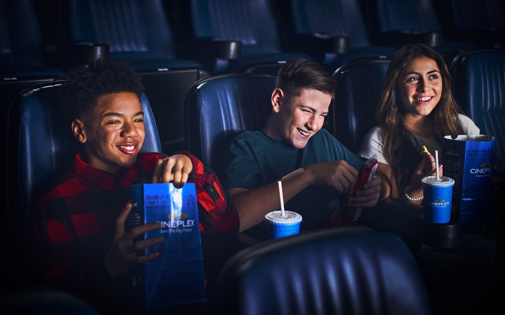 Movie-goers in a theatre with snacks 