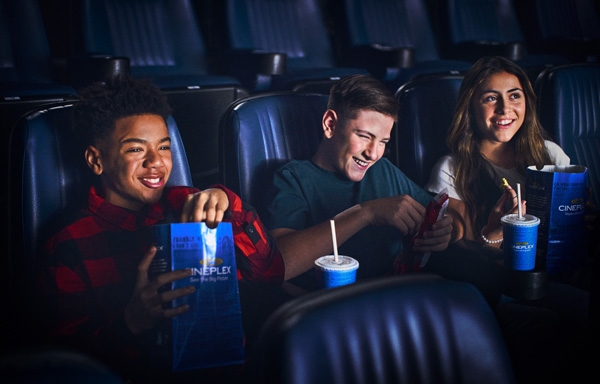 Movie-goers in a theatre with snacks 